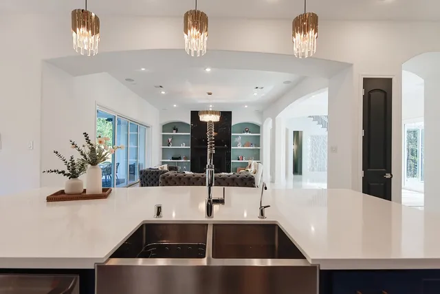 a kitchen with a sink a counter and cabinets