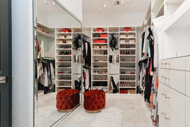 a view of walk in closet with clothes and shoes