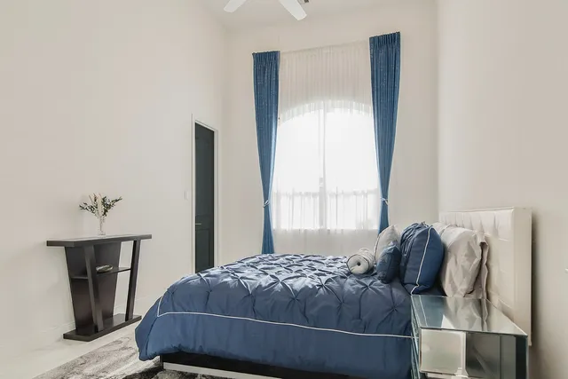 a bedroom with a bed and a window