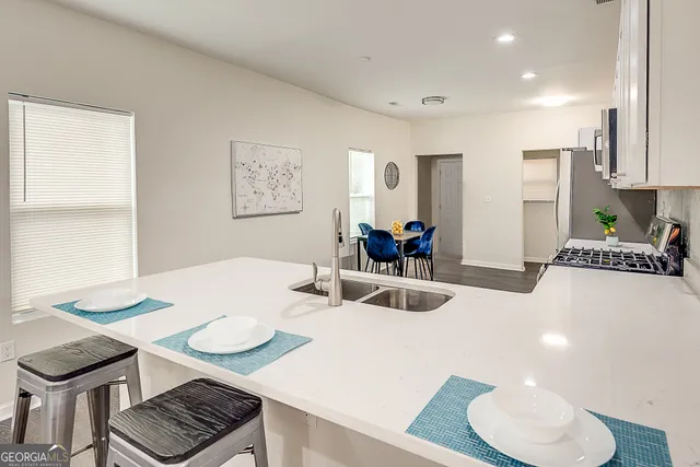 a kitchen with a table and chairs in it