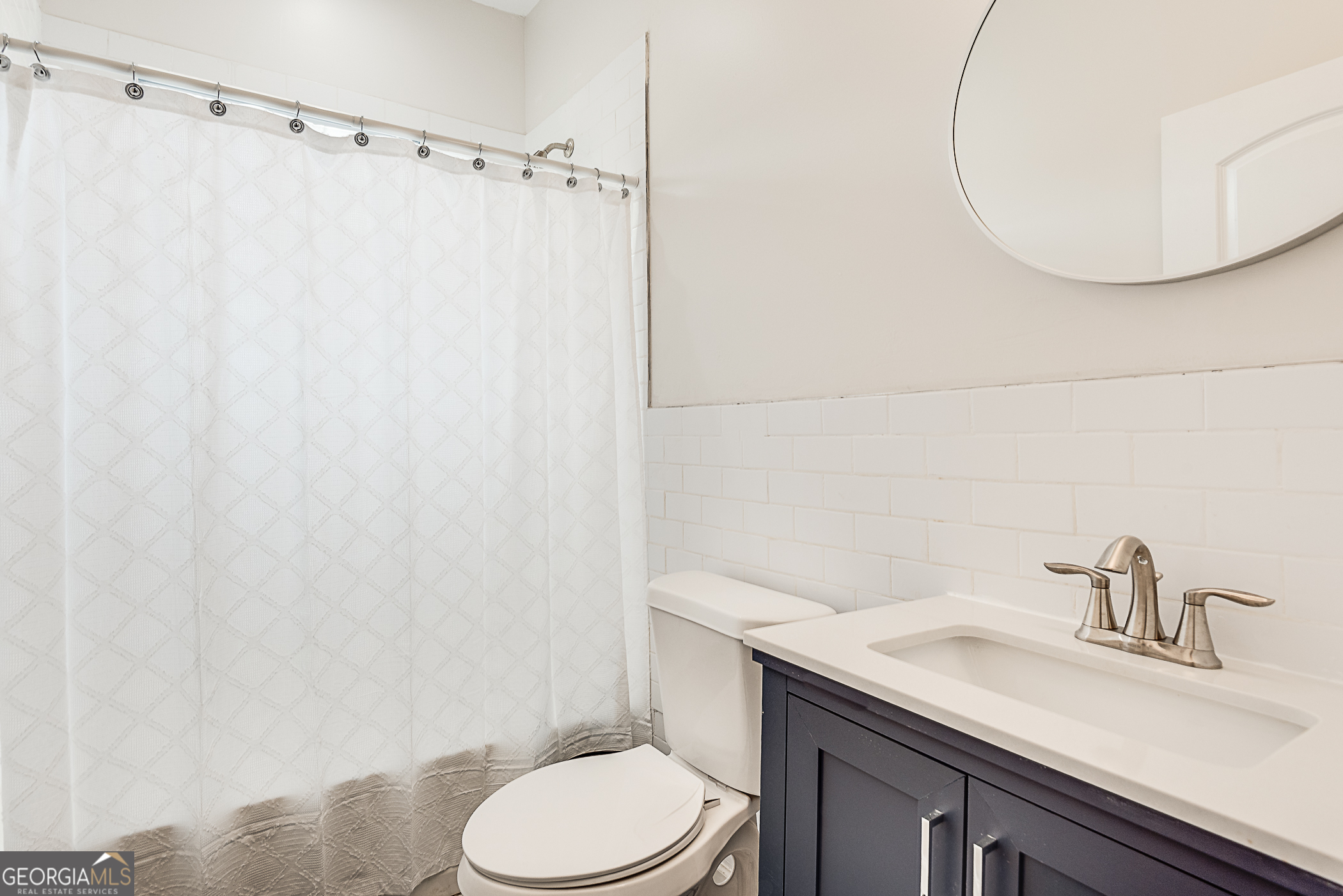 996 Fair Street Southwest Atlanta, GA 30310 - Photo 8 of 8 a bathroom with a granite countertop sink and a mirror