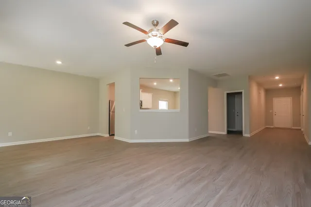 a view of an empty room with a ceiling fan
