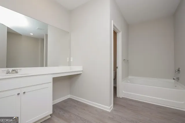 a bathroom with a bathtub and a sink