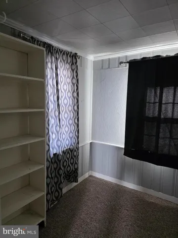 a view of walk in closet with clothes