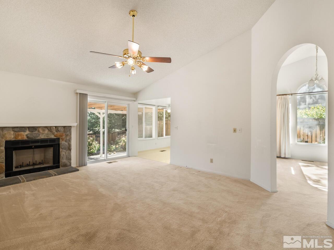 5670 West Rainbow Ridge Court Reno, NV 89523 - Photo 13 of 36 a view of an empty room with a fireplace and a window