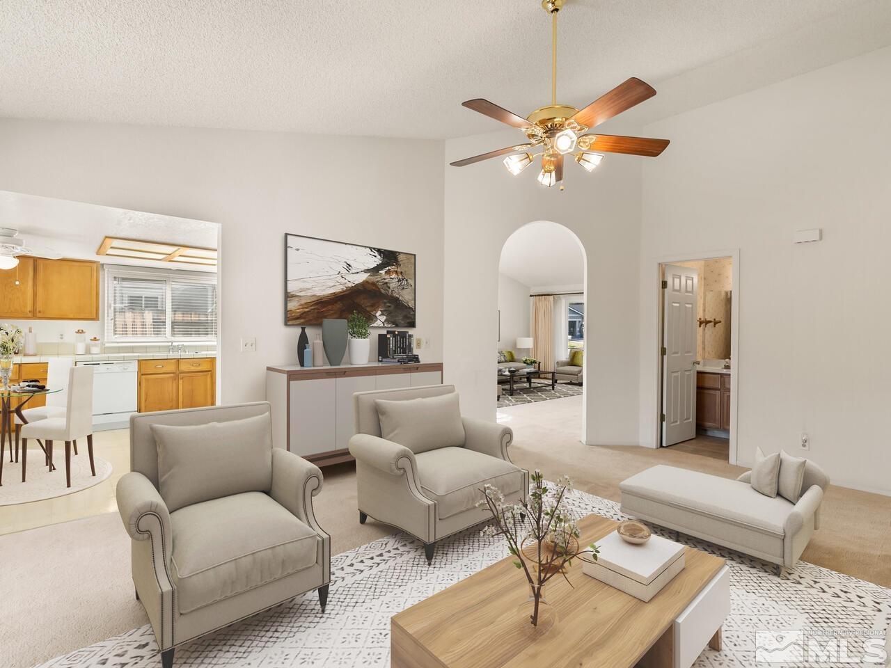 5670 West Rainbow Ridge Court Reno, NV 89523 - Photo 16 of 36 a living room with furniture and a chandelier