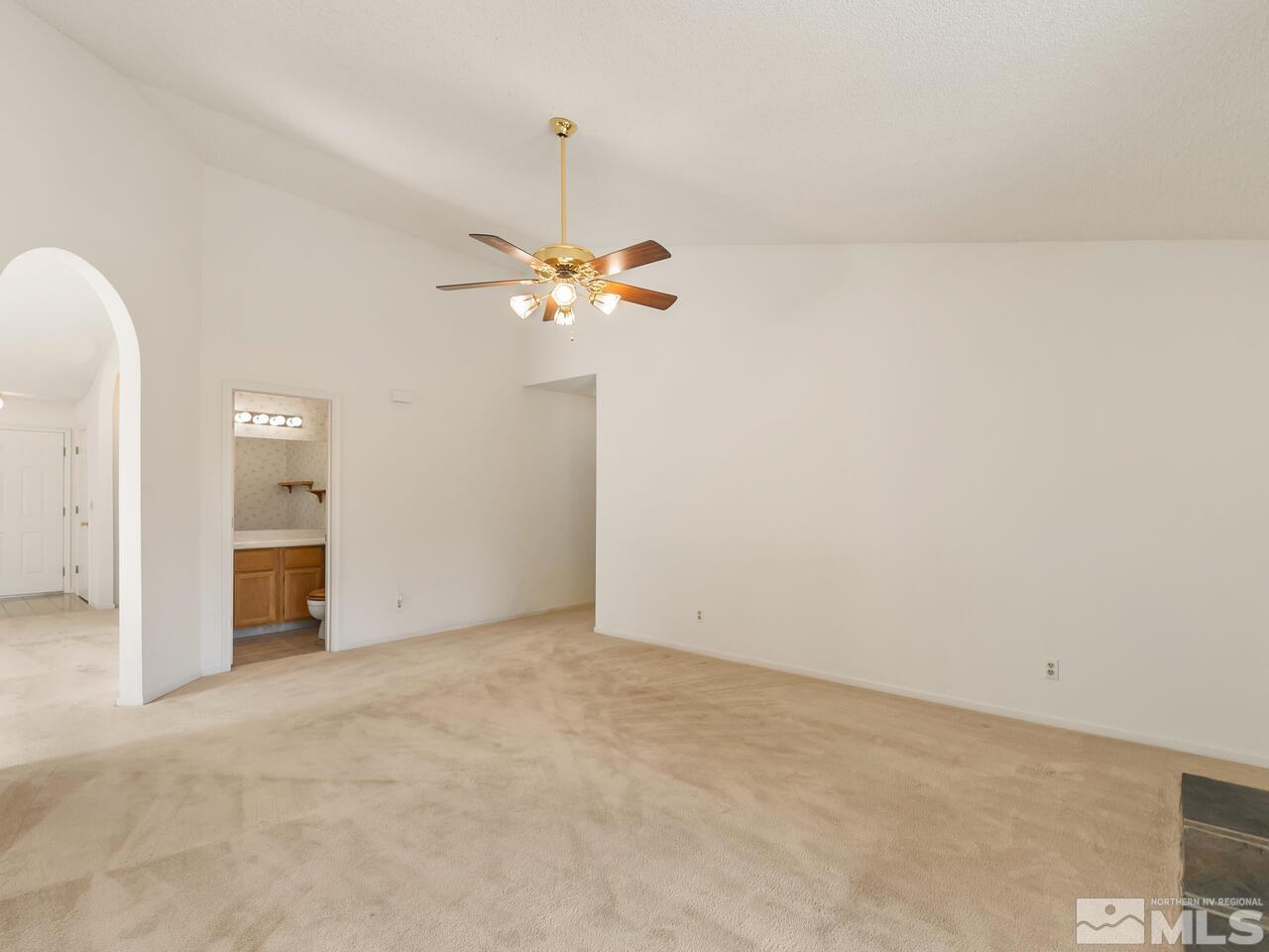 5670 West Rainbow Ridge Court Reno, NV 89523 - Photo 17 of 36 a view of an empty room with a chandelier fan