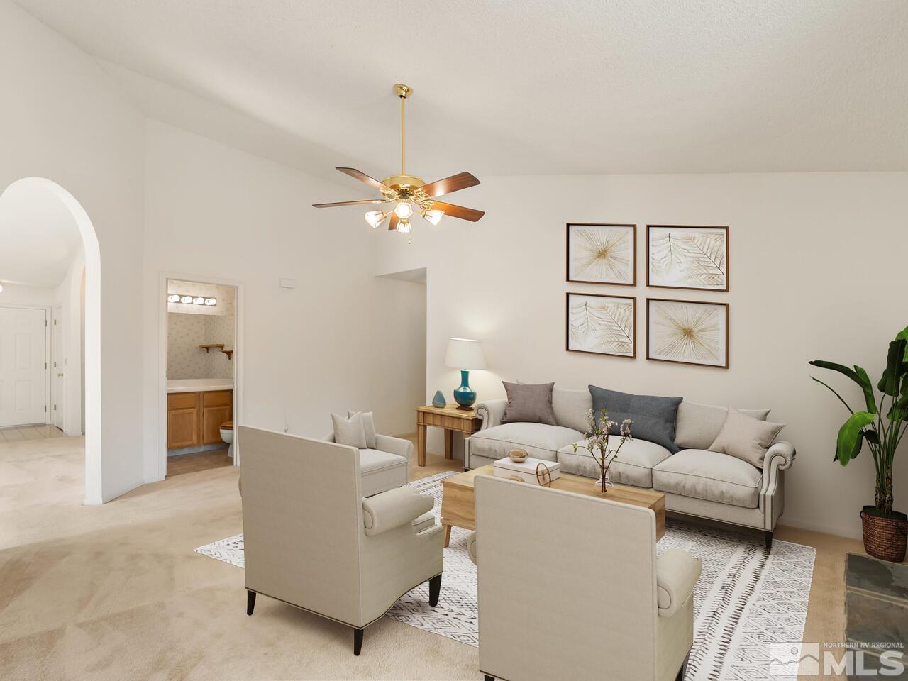 5670 West Rainbow Ridge Court Reno, NV 89523 - Photo 22 of 36 a living room with furniture and a chandelier