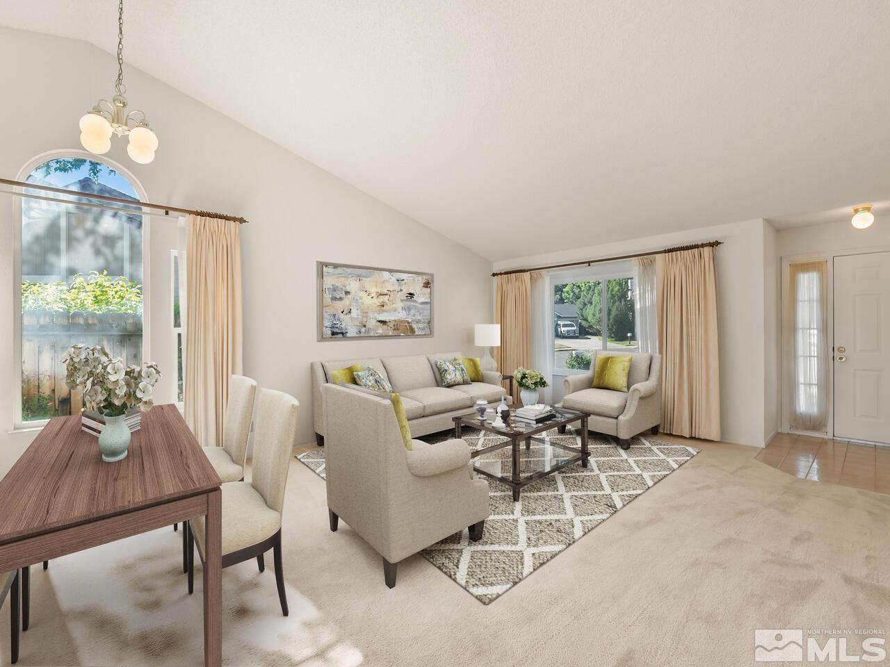 5670 West Rainbow Ridge Court Reno, NV 89523 - Photo 23 of 36 a living room with furniture a table and a chandelier