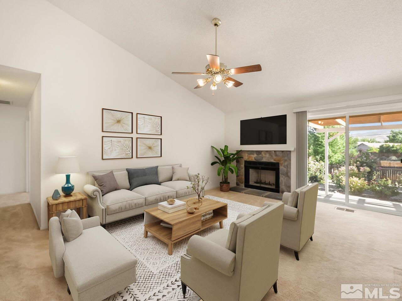 5670 West Rainbow Ridge Court Reno, NV 89523 - Photo 27 of 36 a living room with furniture a fireplace and a flat screen tv