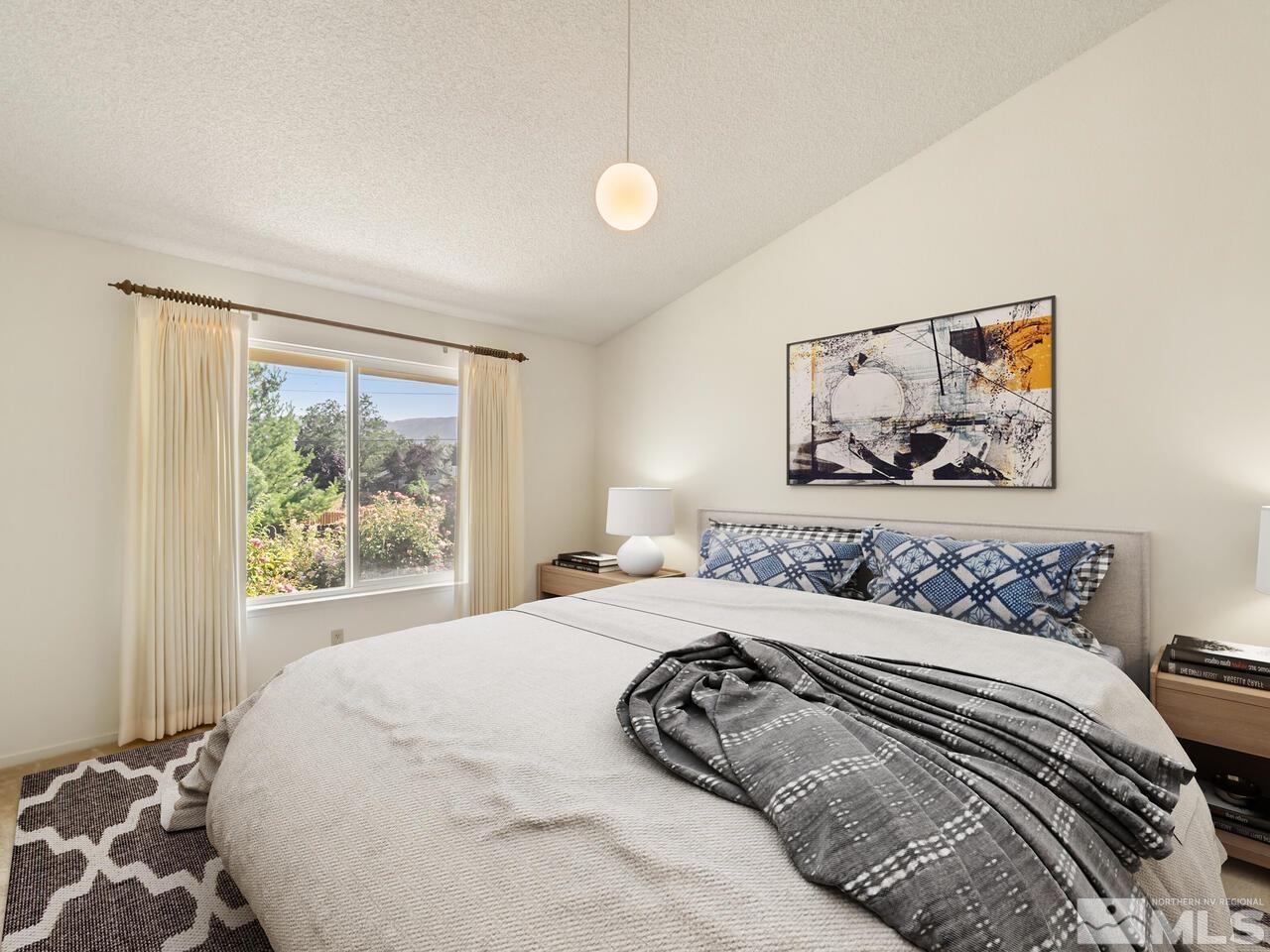 5670 West Rainbow Ridge Court Reno, NV 89523 - Photo 31 of 36 a bedroom with a large bed and a window