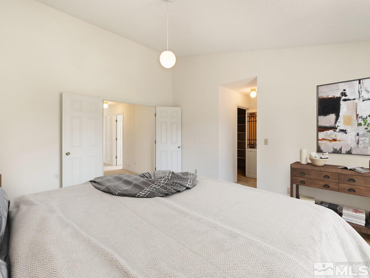 5670 West Rainbow Ridge Court Reno, NV 89523 - Photo 32 of 36 a bedroom with a bed and dresser