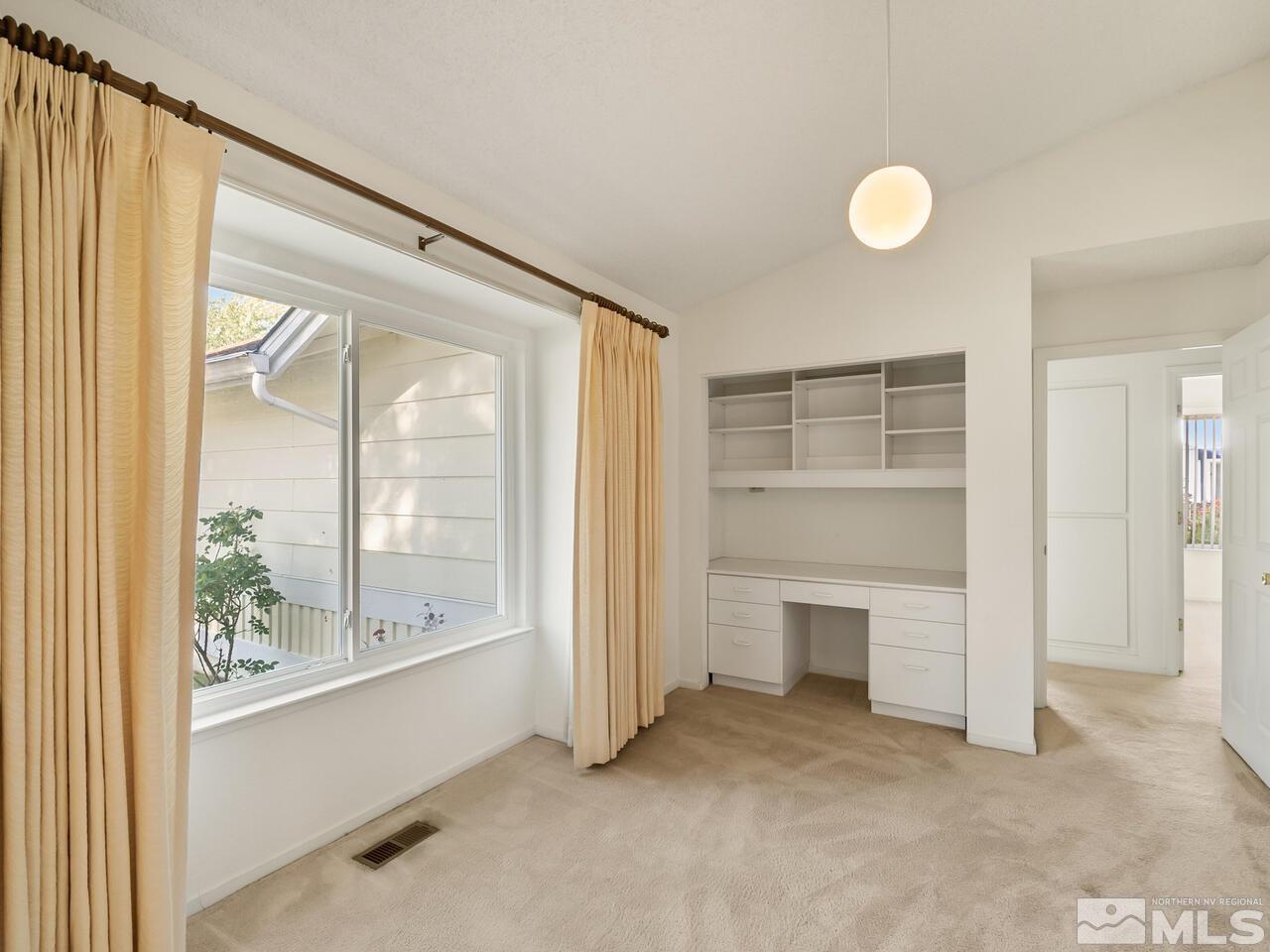 5670 West Rainbow Ridge Court Reno, NV 89523 - Photo 35 of 36 a view of an empty room with a fireplace and a window