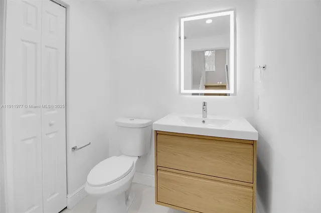 a bathroom with a sink toilet and vanity