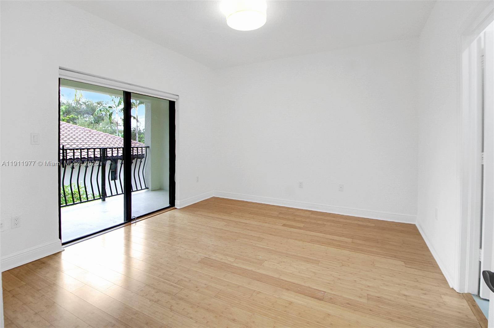 3204 Bird Avenue, Unit 119 Miami, FL 33133 - Photo 16 of 34 a view of a room with wooden floor and windows