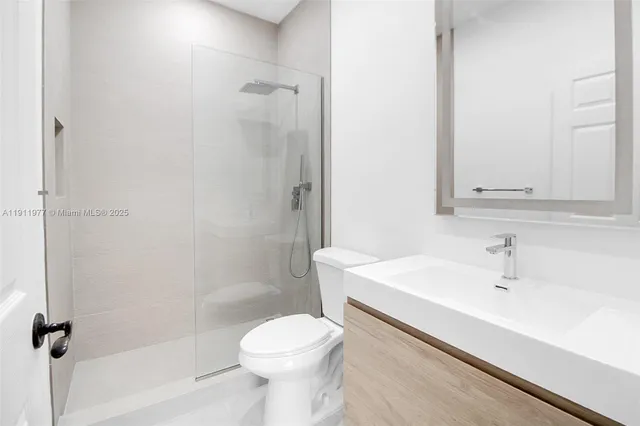 a view of walk in closet with clothes