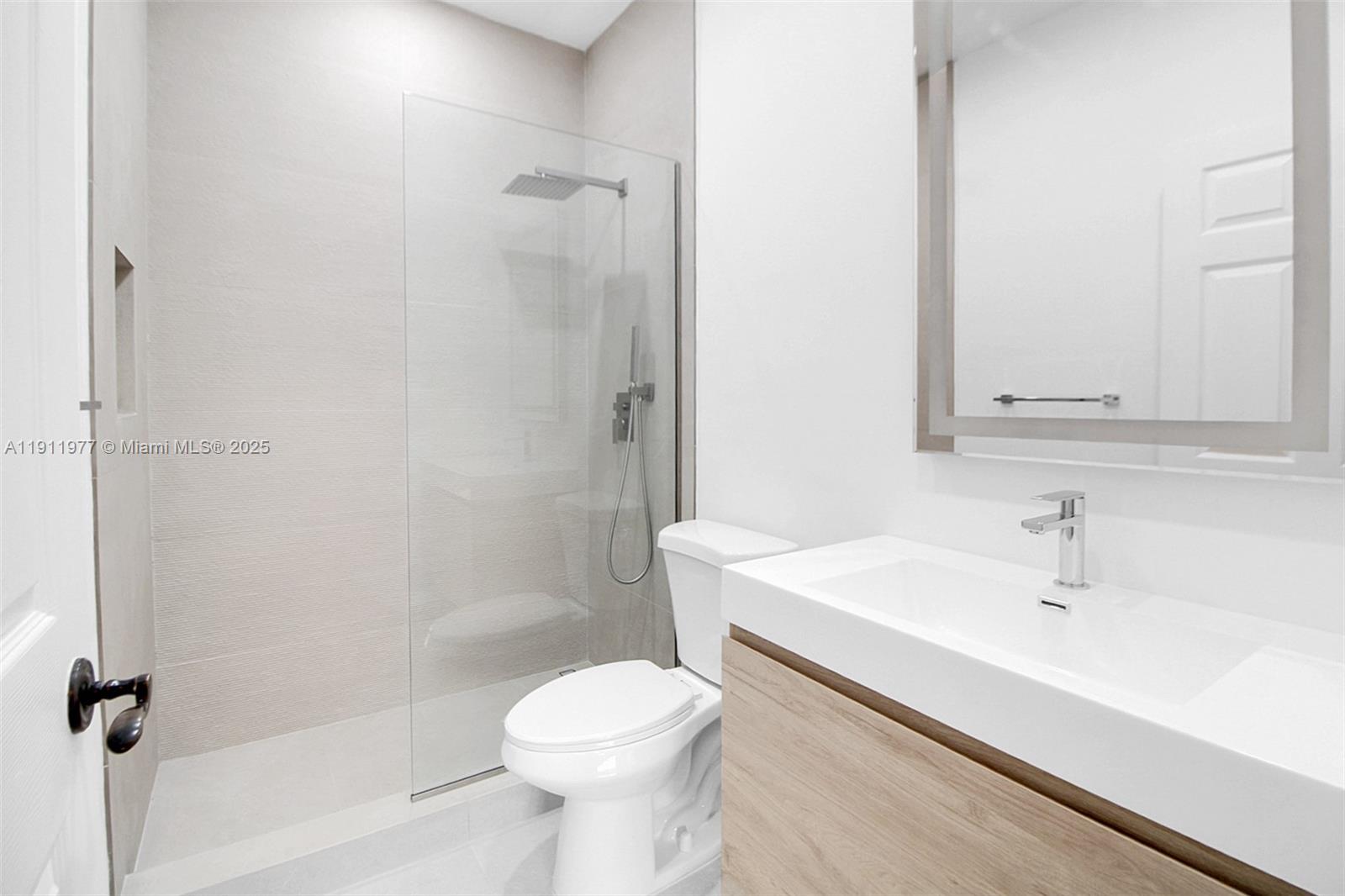 3204 Bird Avenue, Unit 119 Miami, FL 33133 - Photo 20 of 34 a bathroom with a sink a toilet and shower