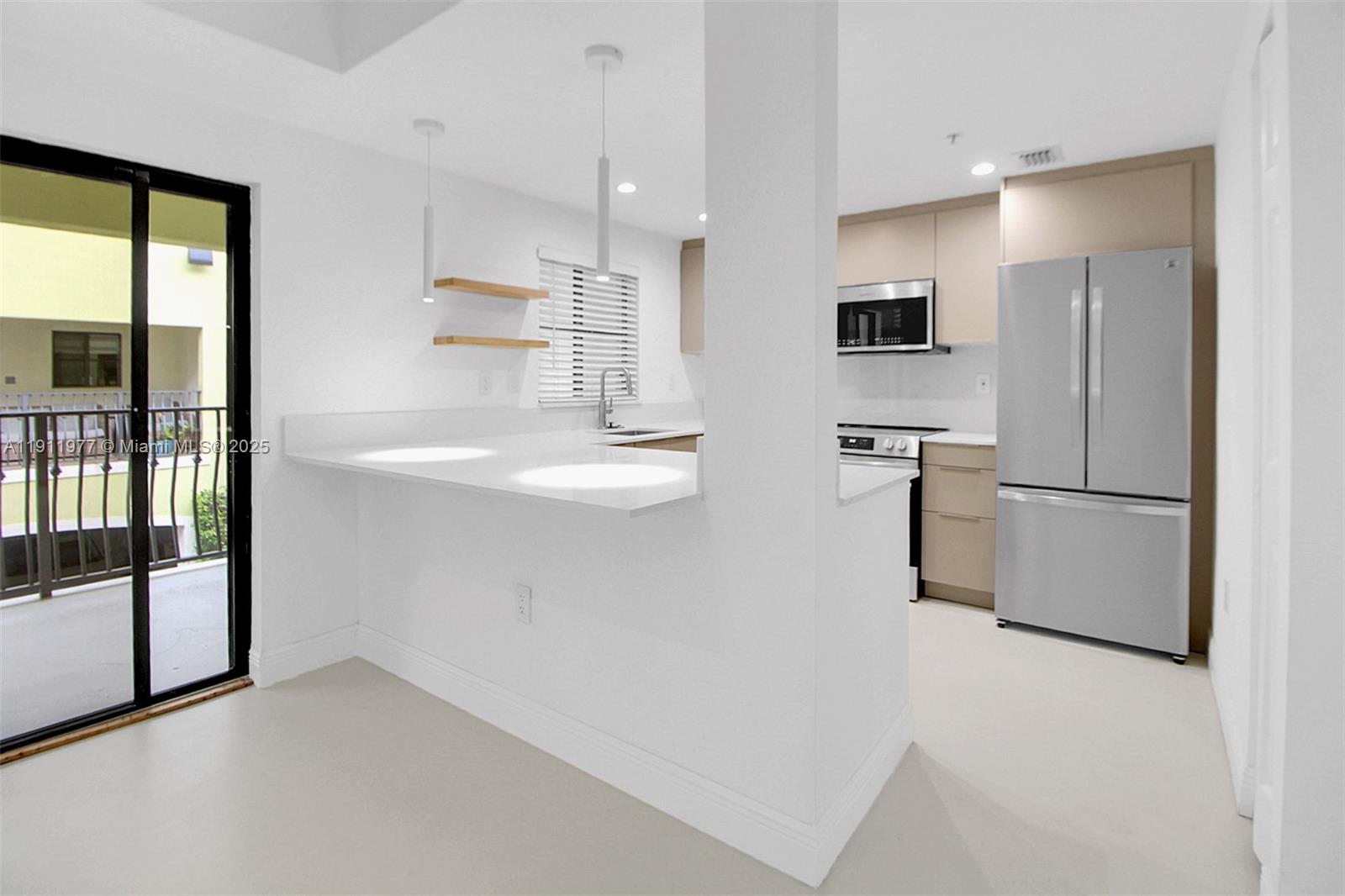 3204 Bird Avenue, Unit 119 Miami, FL 33133 - Photo 10 of 34 a view of kitchen with stainless steel appliances refrigerator oven and cabinets
