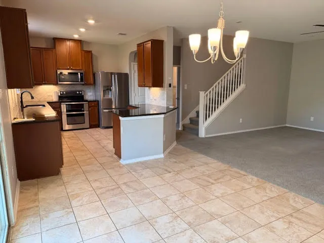 a view of an empty room and a ceiling fan