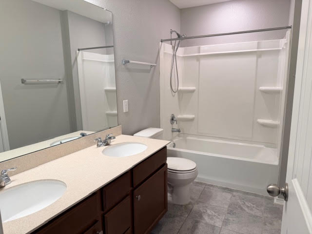 329 Los Cobos Lane Georgetown, TX 78626 - Photo 27 of 40 a bathroom with a sink a toilet a mirror and shower
