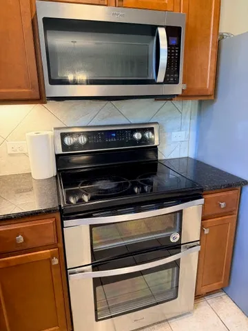 a stove top oven sitting inside of a kitchen