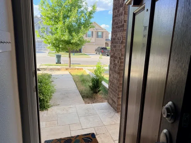 a view of staircase with lots of frames on wall and stairs