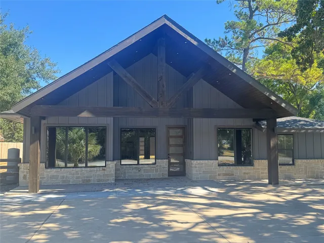 a view of a house with entrance door and a yard