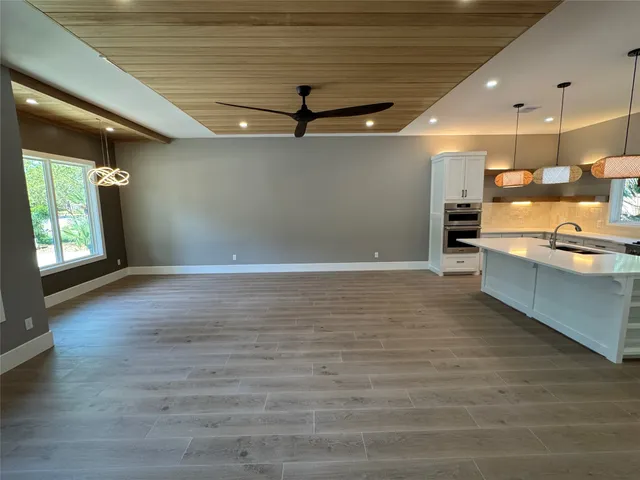 a view of a kitchen with a sink and a large window