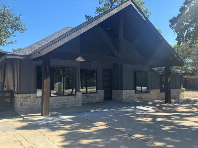 a view of a patio with table and chairs and floor to ceiling window