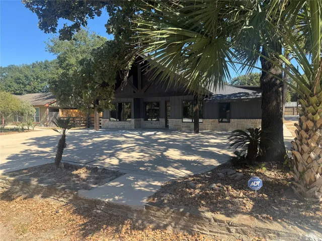 a backyard of a house with table and chairs