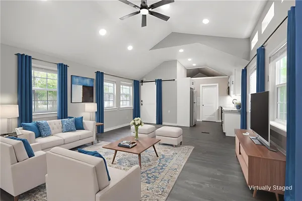 a living room with furniture and a flat screen tv