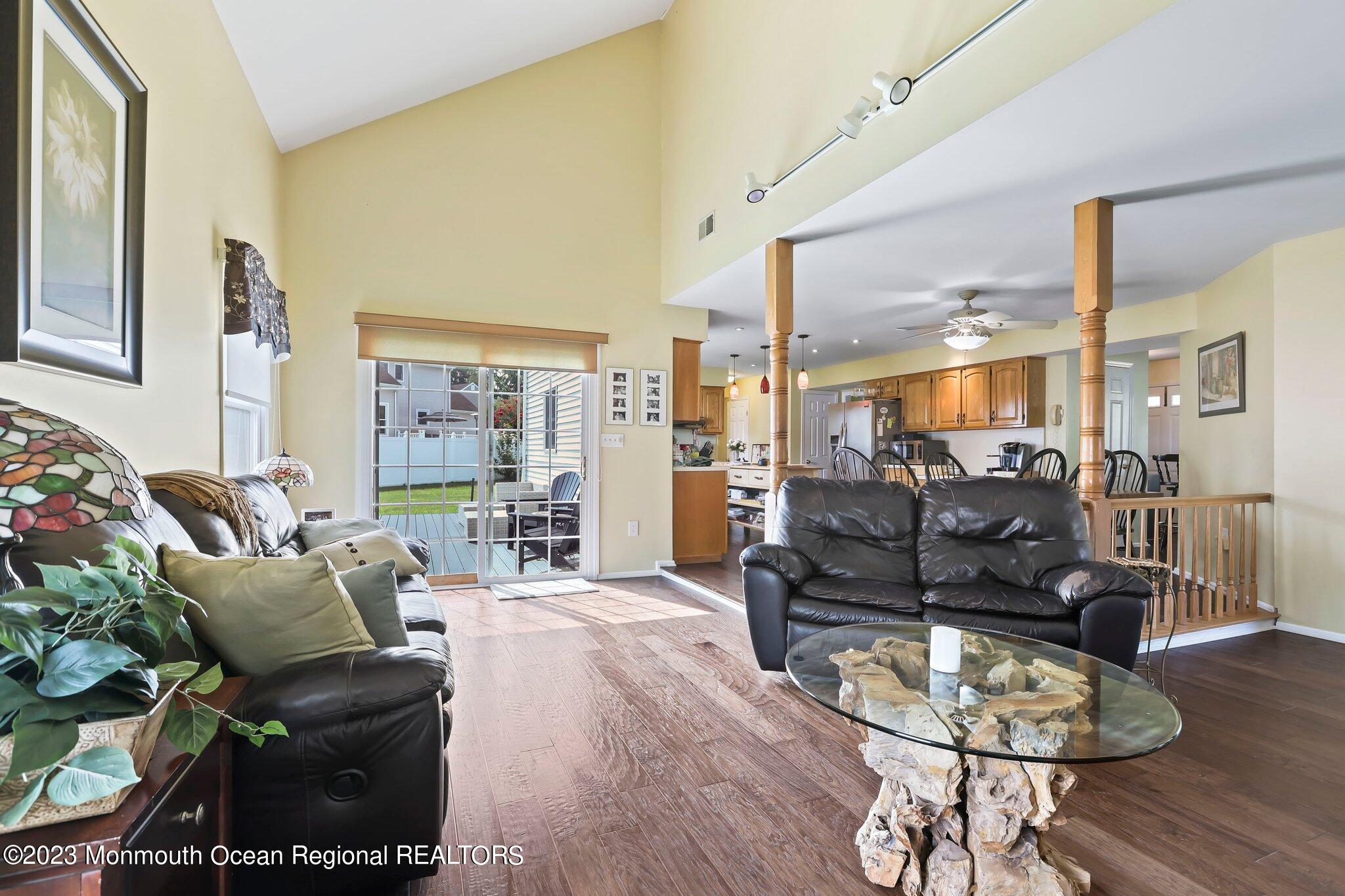 31 Daniel Drive Hazlet, NJ 07730 - Photo 16 of 31 a living room with furniture and a dining table with wooden floor