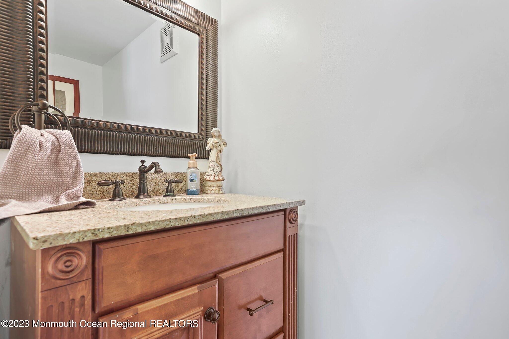 31 Daniel Drive Hazlet, NJ 07730 - Photo 18 of 31 a bathroom with a granite countertop sink and a mirror