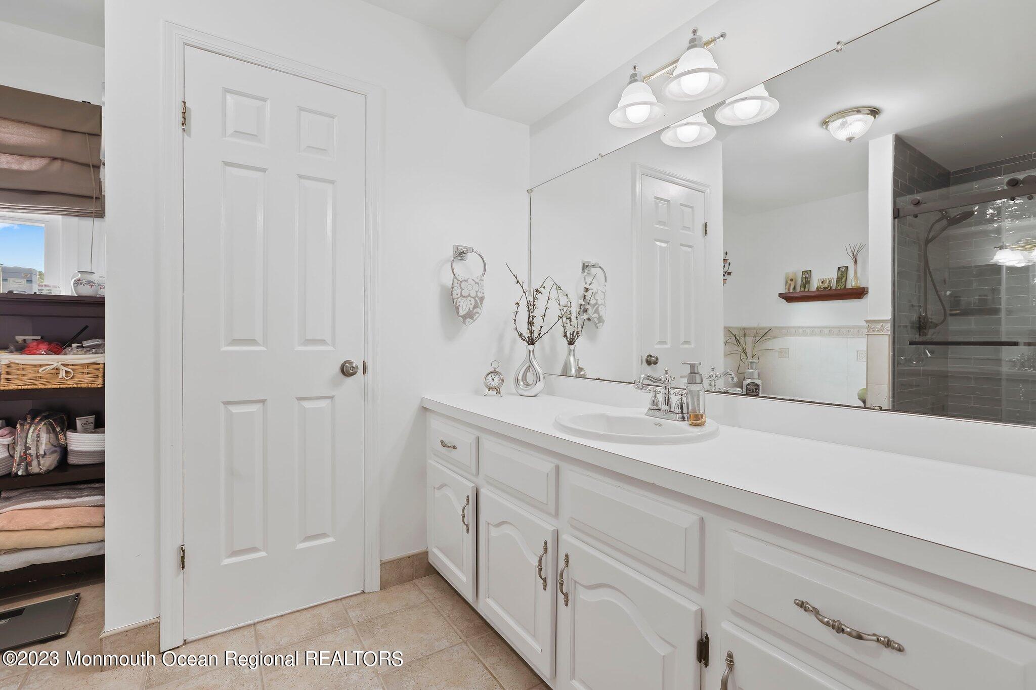 31 Daniel Drive Hazlet, NJ 07730 - Photo 21 of 31 a bathroom with a sink a vanity and a mirror