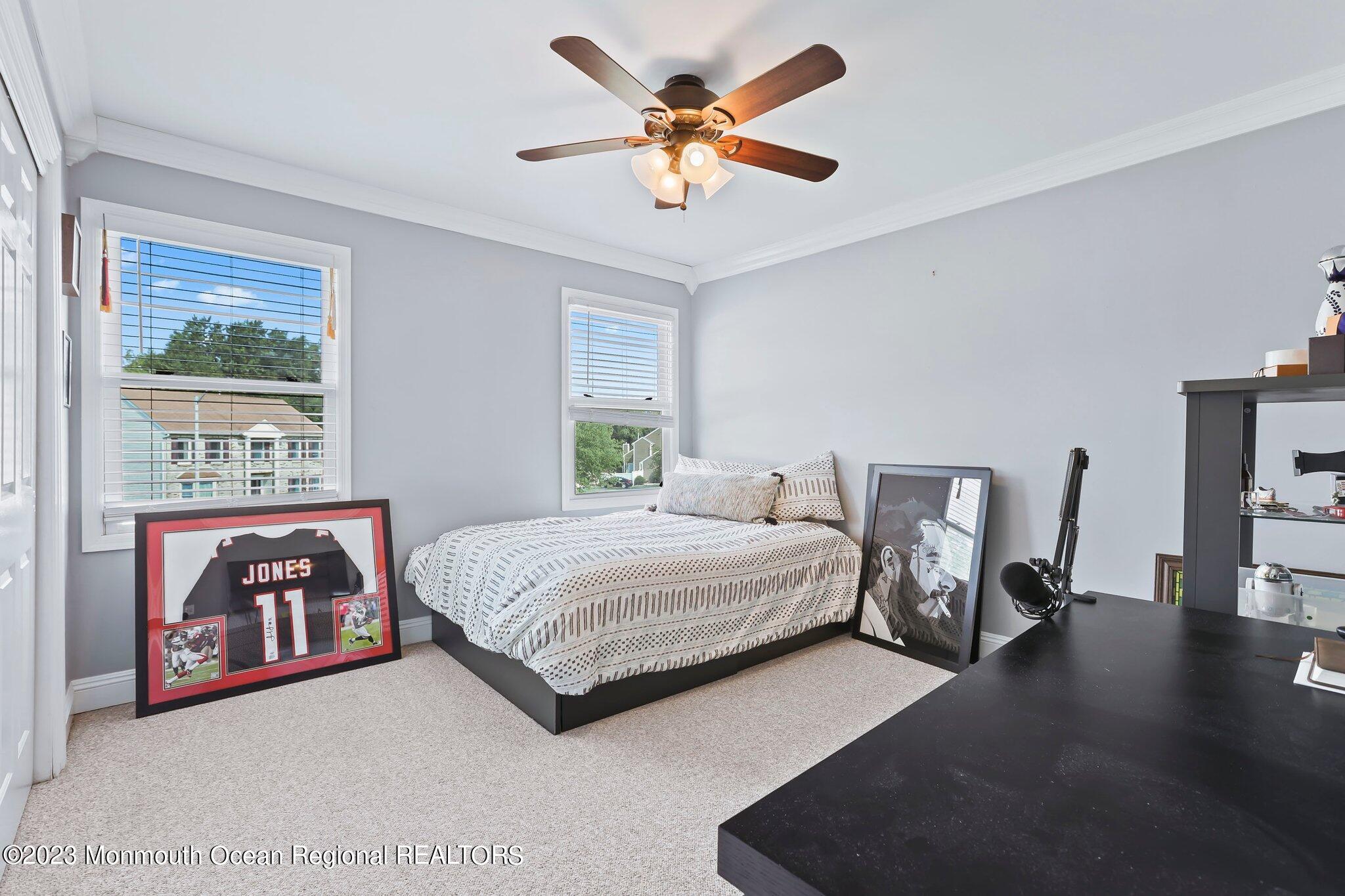 31 Daniel Drive Hazlet, NJ 07730 - Photo 22 of 31 a spacious bedroom with a bed and a chandelier