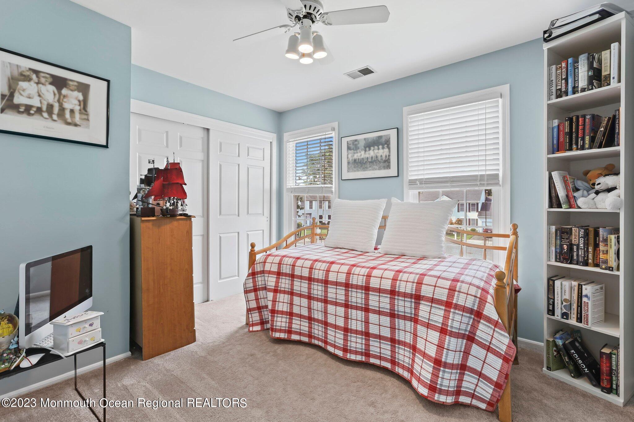 31 Daniel Drive Hazlet, NJ 07730 - Photo 24 of 31 a bedroom with a bed and a book shelf