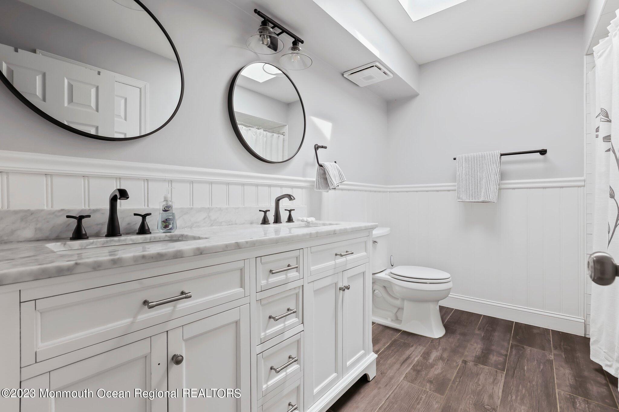 31 Daniel Drive Hazlet, NJ 07730 - Photo 25 of 31 a bathroom with a toilet a sink and a mirror