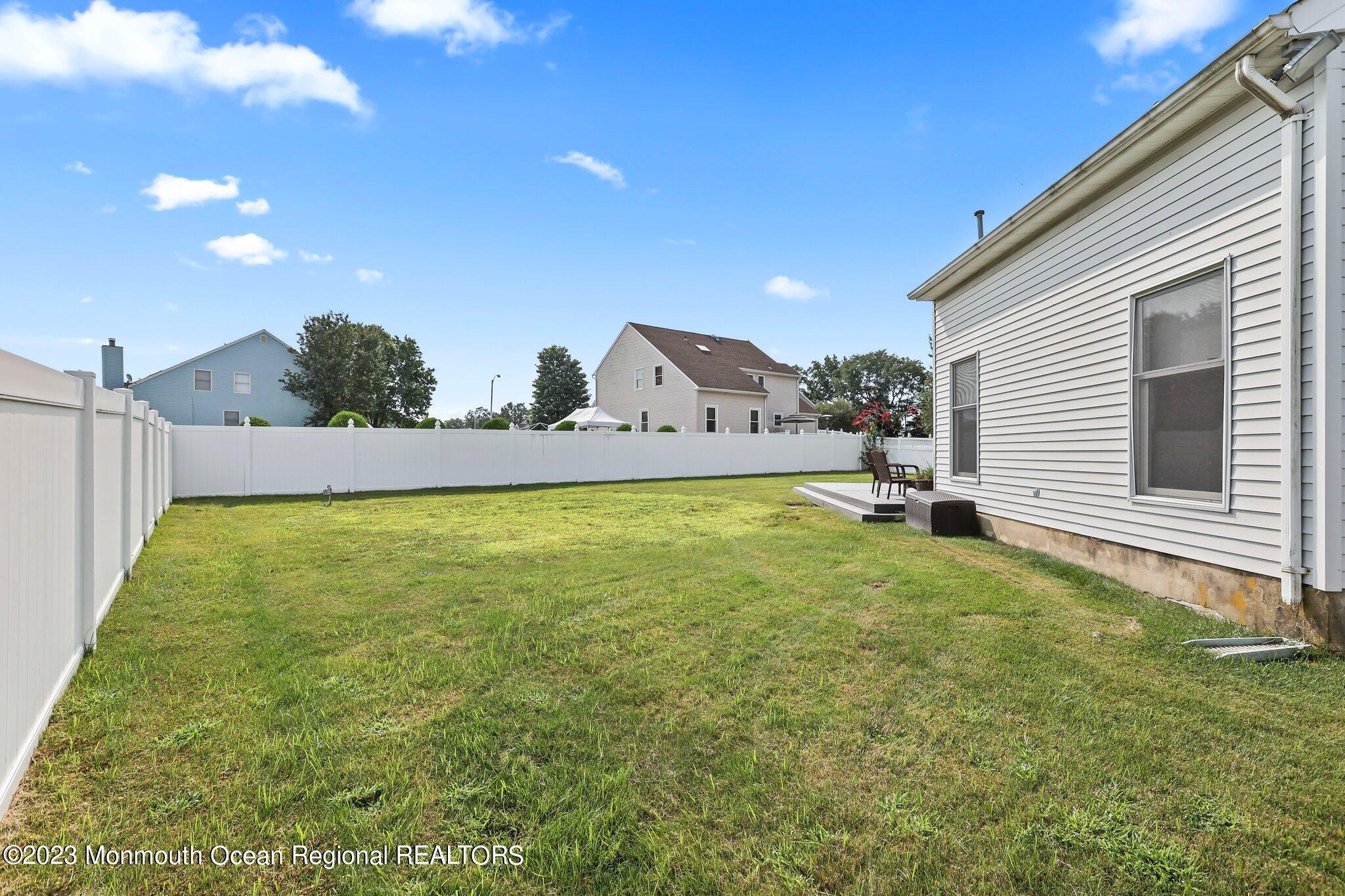 31 Daniel Drive Hazlet, NJ 07730 - Photo 30 of 31 a view of a backyard with plants and large trees