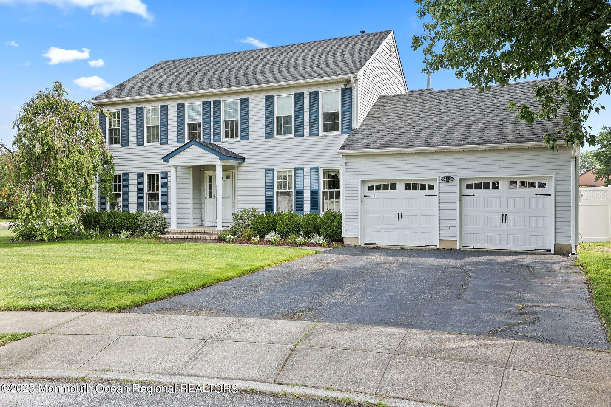 31 Daniel Drive Hazlet, NJ 07730 - Photo 3 of 31 a front view of a house with a yard and garage
