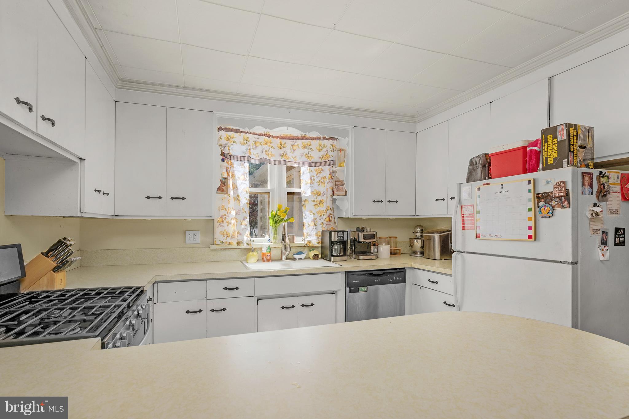730 McAllister Street Hanover, PA 17331 - Photo 12 of 46 a kitchen with white cabinets and white appliances