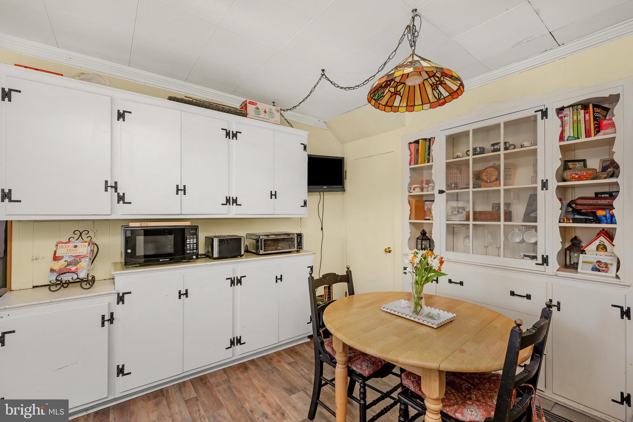 730 McAllister Street Hanover, PA 17331 - Photo 14 of 46 a kitchen with stainless steel appliances kitchen island granite countertop a table and chairs in it