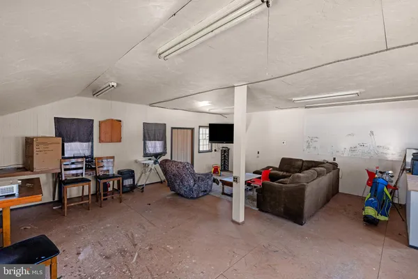 a bed room with furniture and flat screen tv