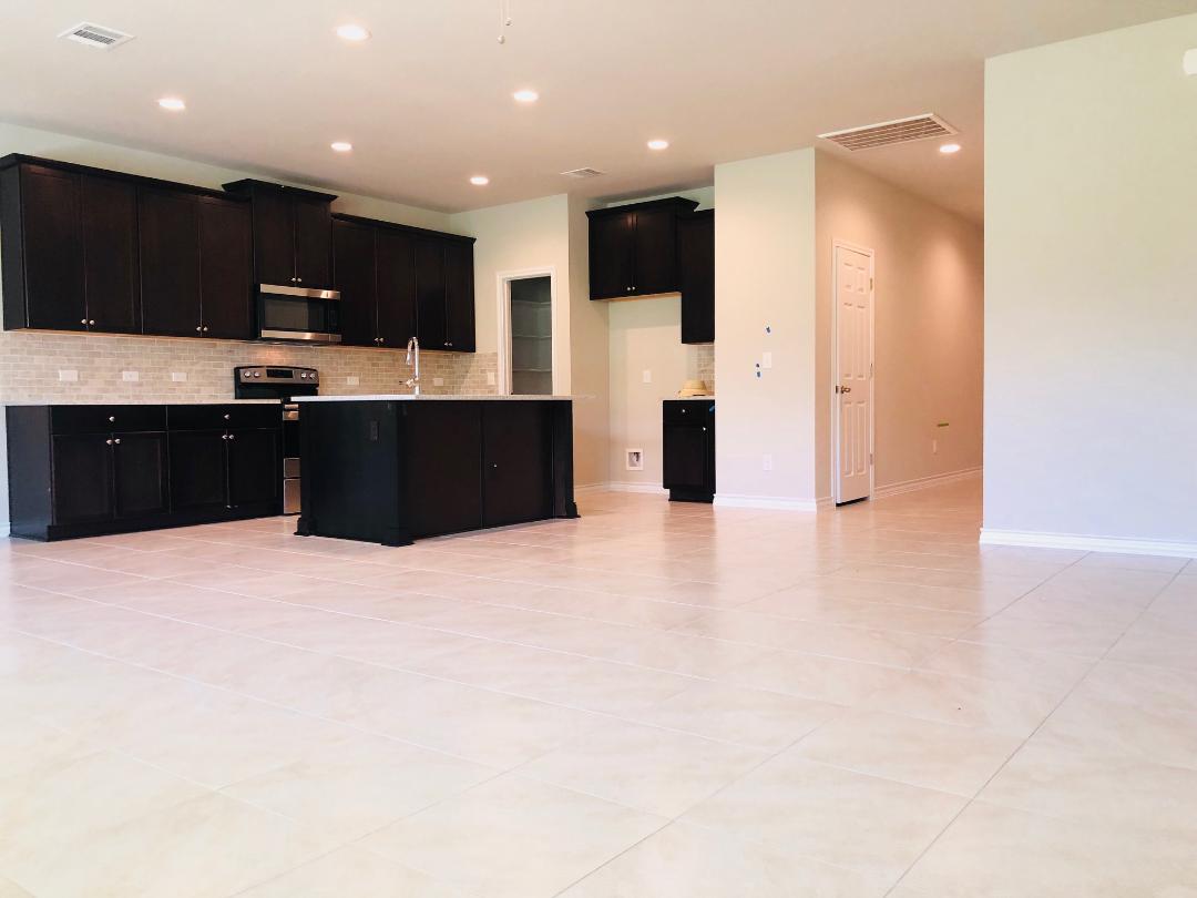 1308 Eagle Ridge Trail Leander, TX 78641 - Photo 15 of 16 Kitchen featuring dark cabinets, stainless steel appliances, an island with sink, open floor plan, and recessed lighting