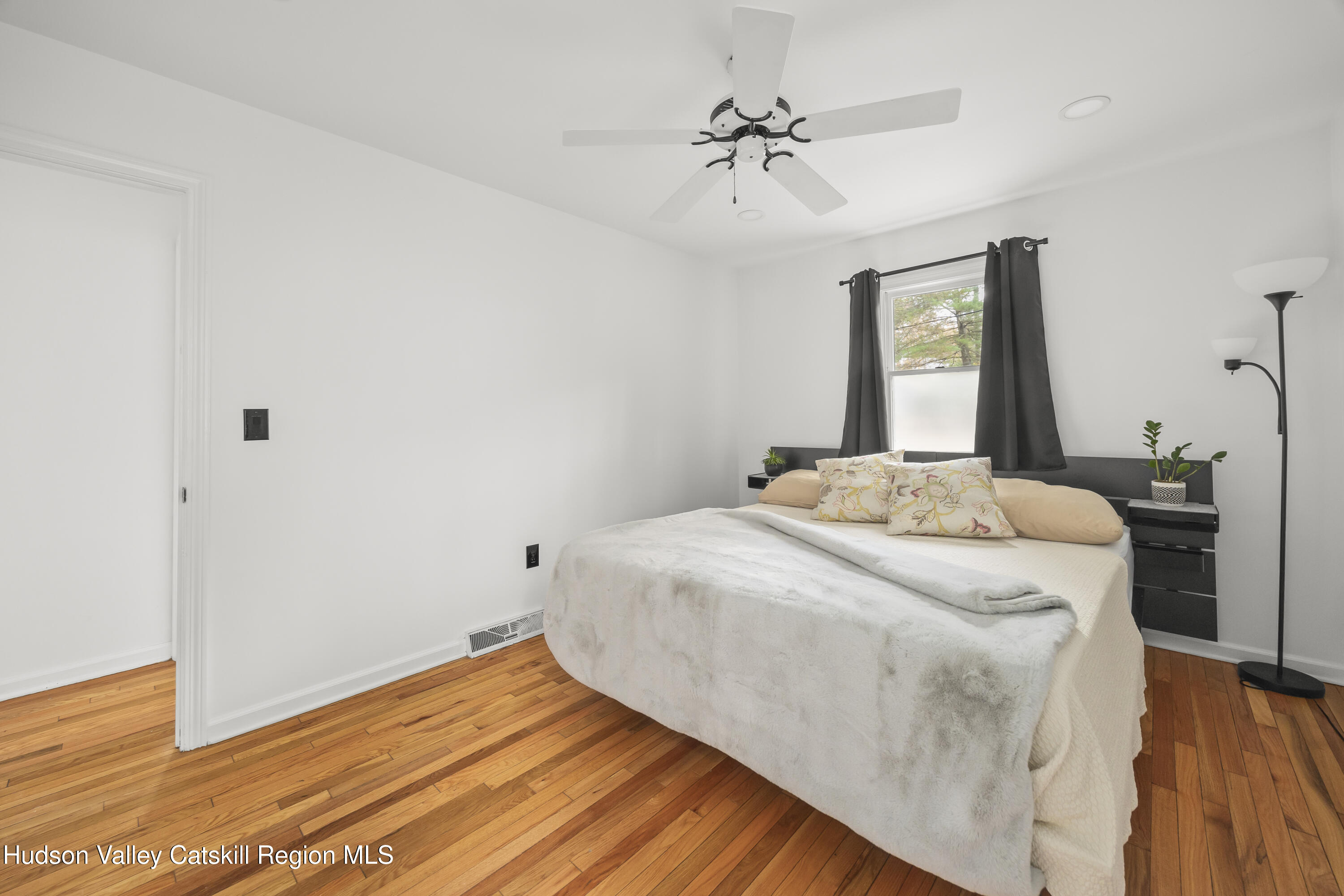 1256 Lakeview Road Copake, NY 12516 - Photo 21 of 37 a bedroom with a bed and wooden floor