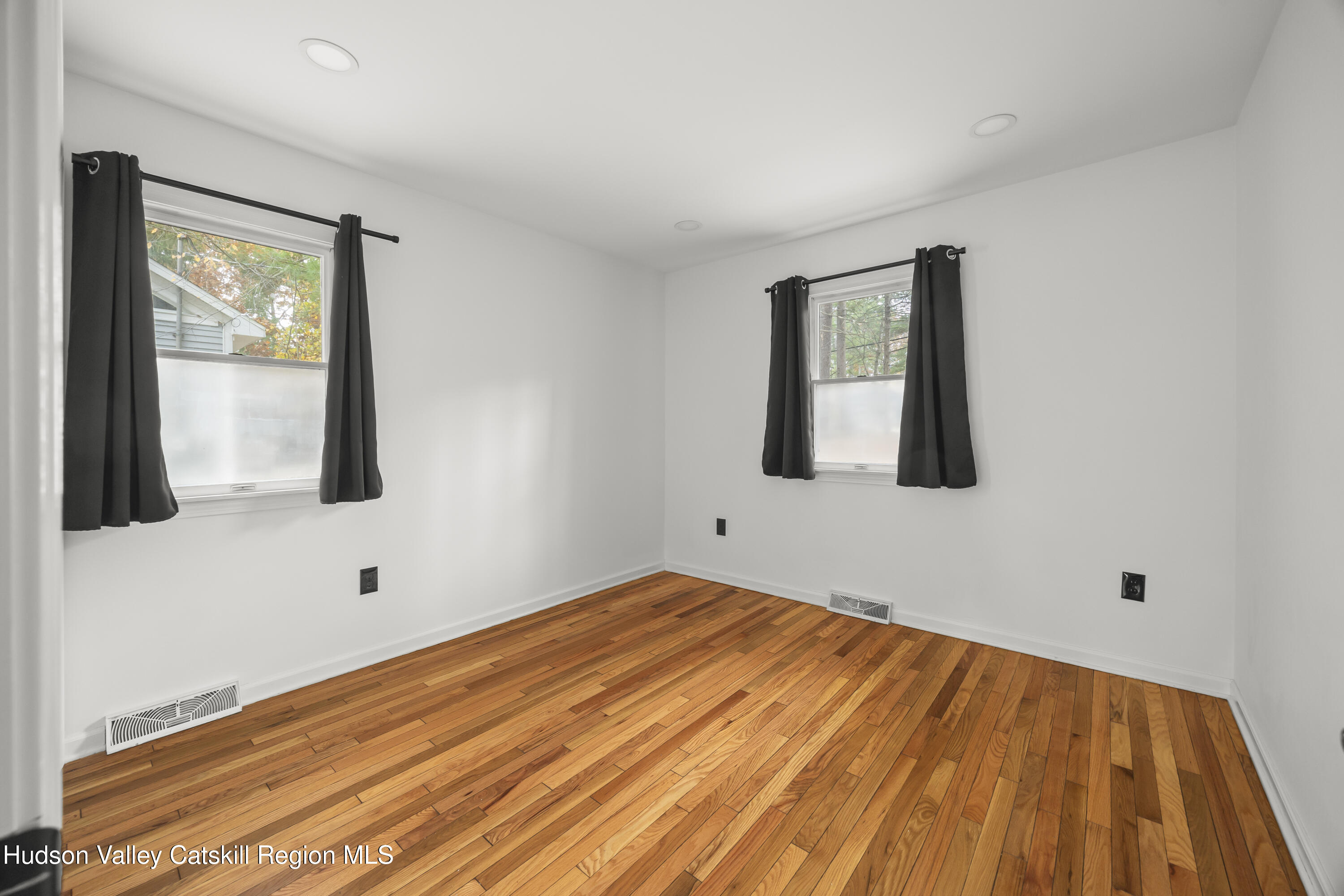1256 Lakeview Road Copake, NY 12516 - Photo 22 of 37 a view of an empty room with wooden floor and a window