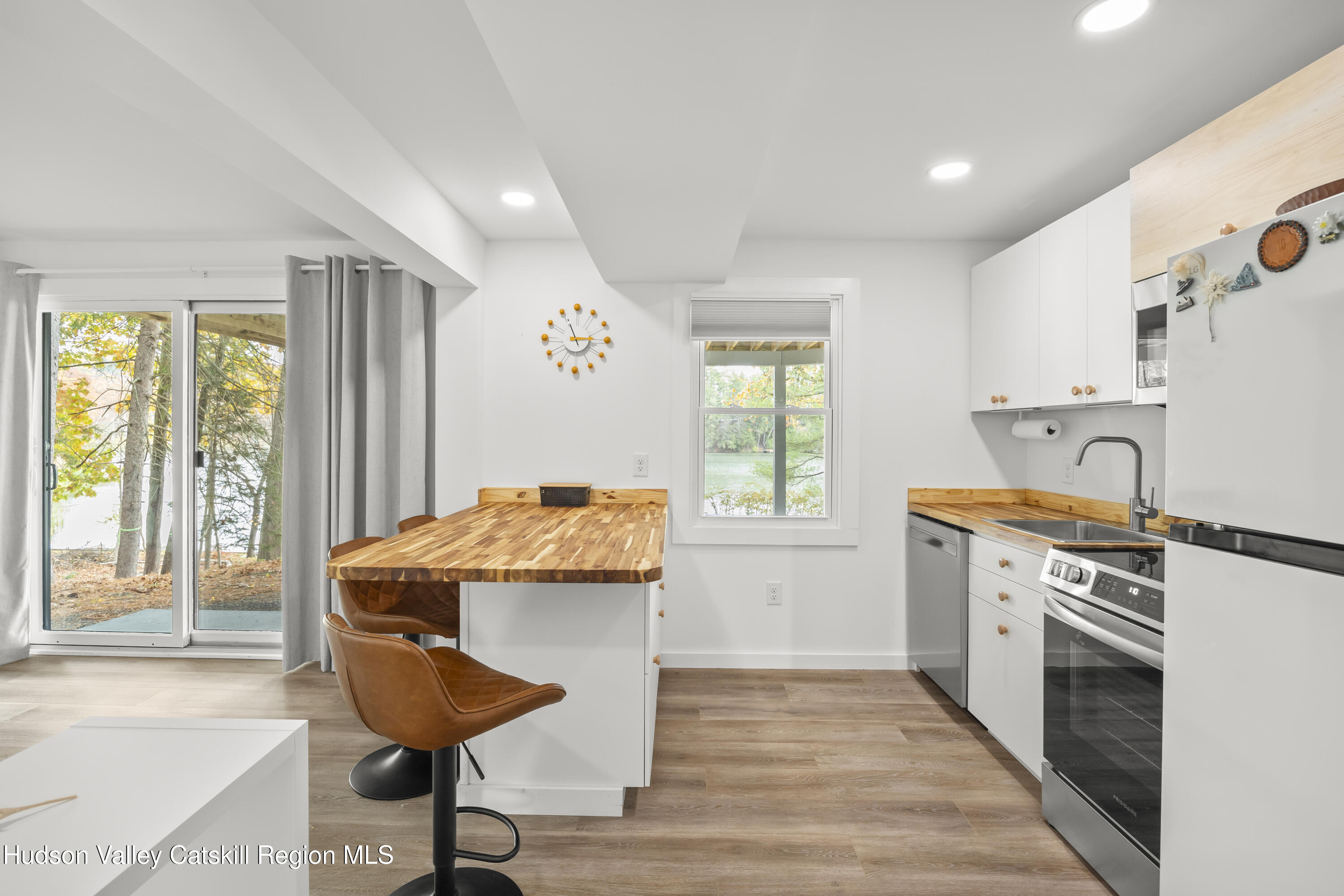 1256 Lakeview Road Copake, NY 12516 - Photo 26 of 37 a kitchen that has a stove a sink and a table in it