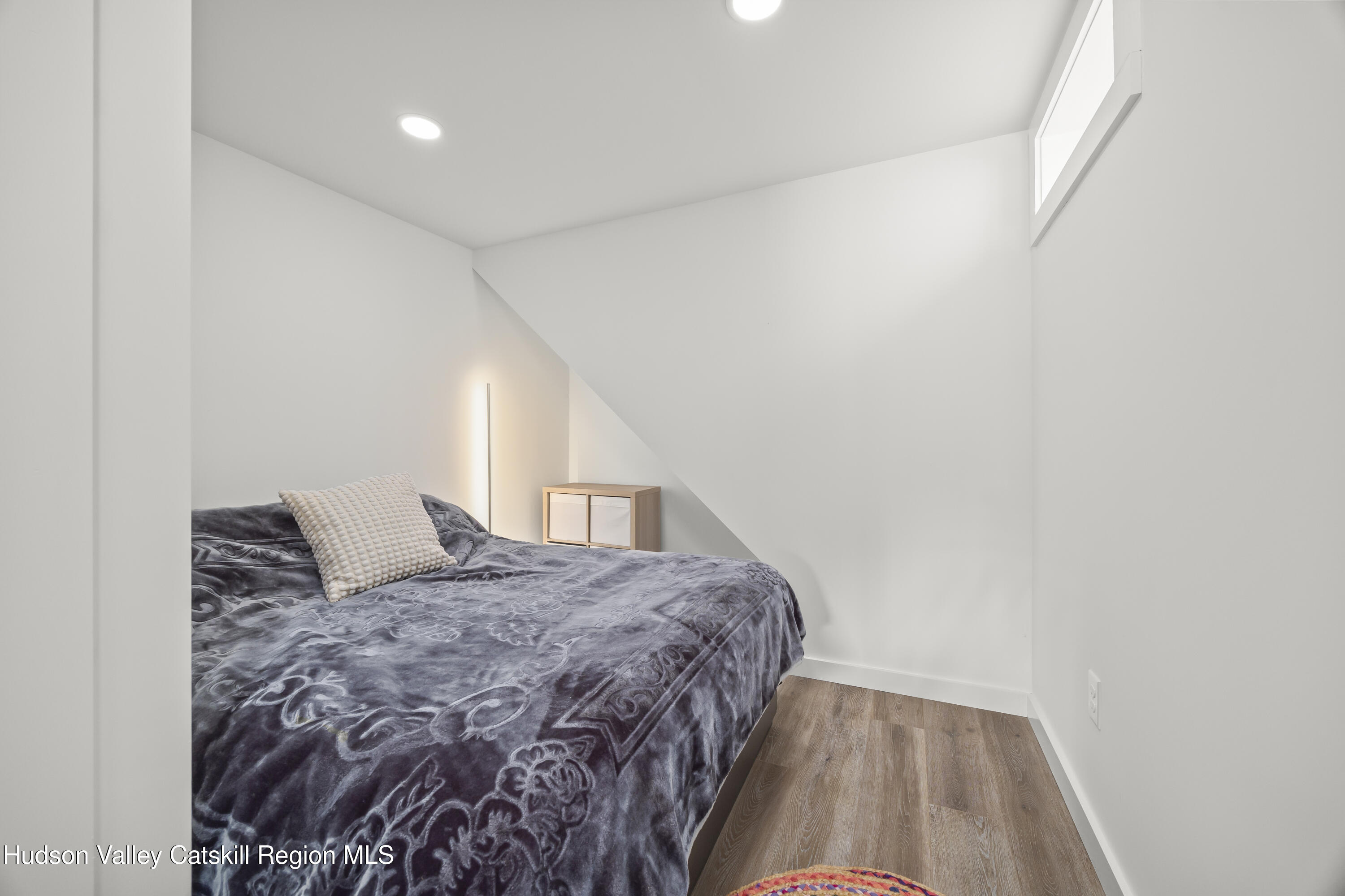 1256 Lakeview Road Copake, NY 12516 - Photo 33 of 37 a bedroom with a bed and wooden floor