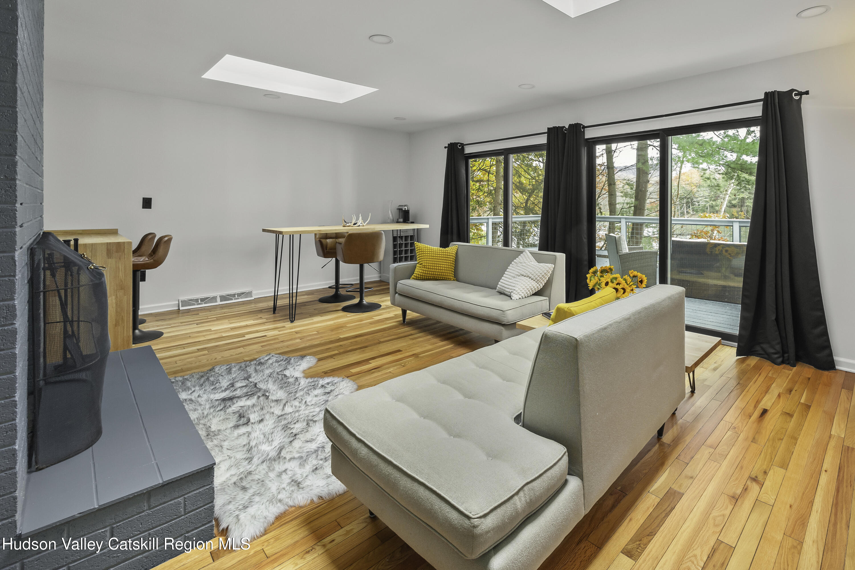 1256 Lakeview Road Copake, NY 12516 - Photo 10 of 37 a living room with furniture and a floor to ceiling window