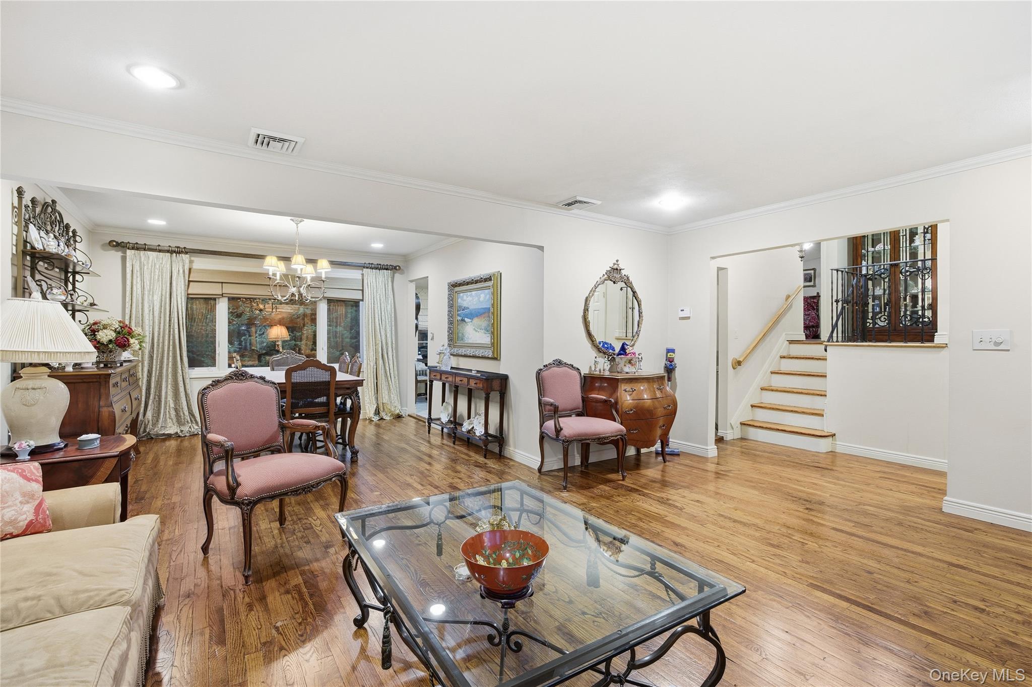 7 Judith Street Plainview, NY 11803 - Photo 12 of 45 Living room featuring crown molding, a chandelier, stairway, light wood-style flooring, and recessed lighting