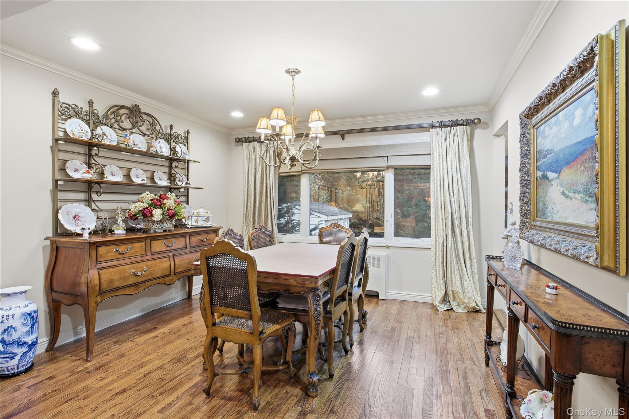 7 Judith Street Plainview, NY 11803 - Photo 13 of 45 Dining room with ornamental molding, wood finished floors, a chandelier, radiator heating unit, and recessed lighting